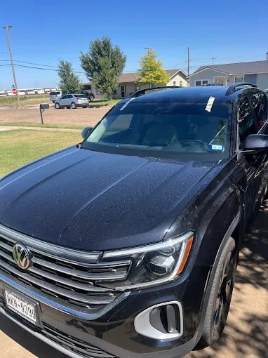 Black Volkswagen SUV parked in suburban residential area
